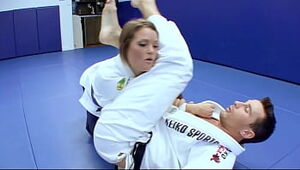 Mischievous Karate students romps with her trainer after a supreme karate session
